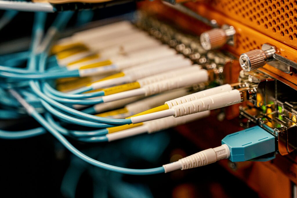 Detailed view of fiber optic cables connected to equipment in a data center.